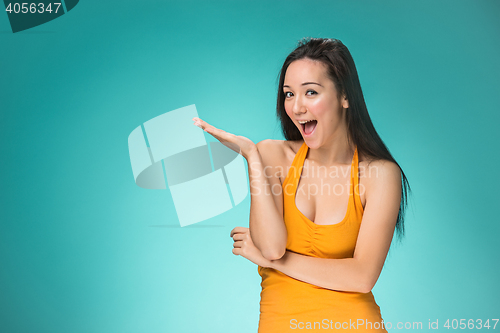 Image of The happy Chinese girl on yellow background