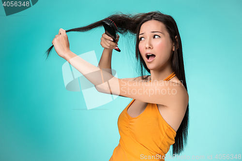 Image of Frustrated young woman having a bad hair