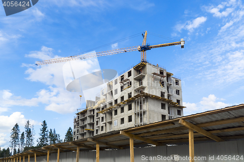 Image of Construction of modern skyscraper with crane