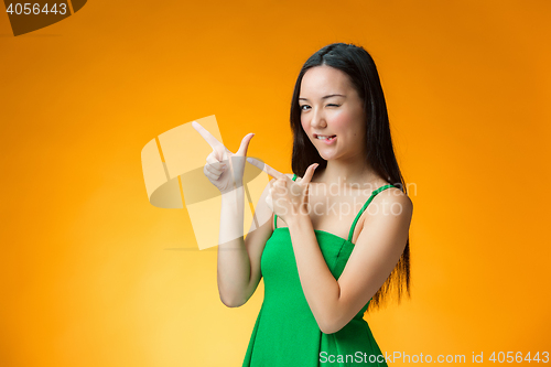 Image of The happy Chinese girl on yellow background