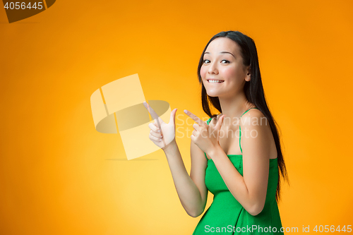 Image of The happy Chinese girl on yellow background