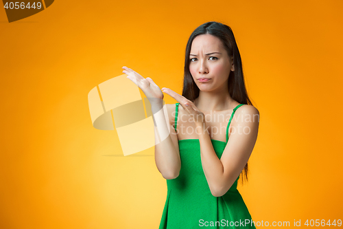 Image of The thinking Chinese girl on yellow background