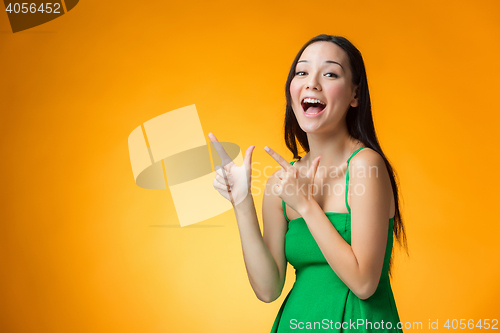 Image of The happy Chinese girl on yellow background