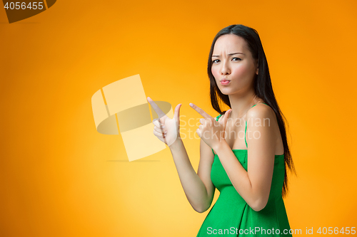 Image of The happy Chinese girl on yellow background