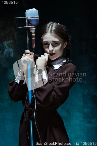 Image of Portrait of a young girl in school uniform as a vampire woman