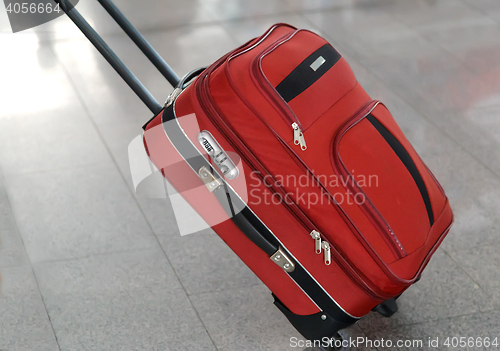 Image of Convenient suitcase on wheels with handle.