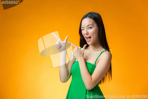 Image of The happy Chinese girl on yellow background