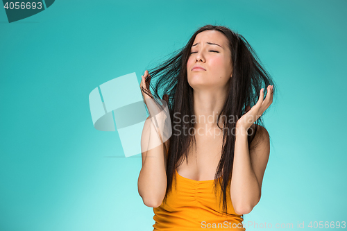 Image of Frustrated young woman having a bad hair