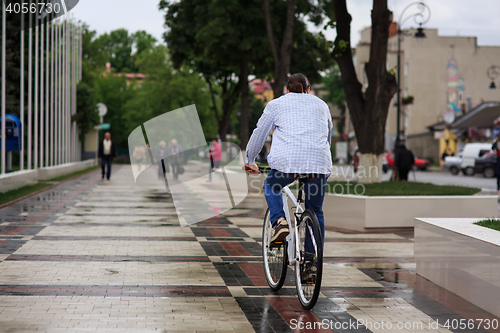 Image of young hipster man with fixed gear bike on city street