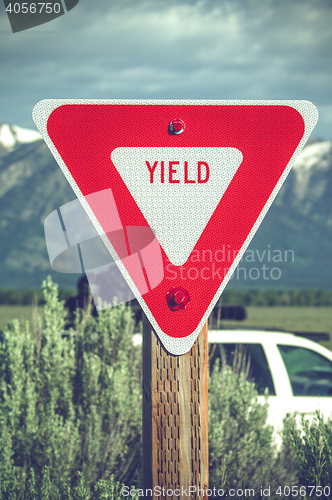 Image of Large red yield sign in a countryside