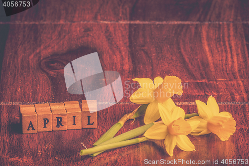 Image of Daffodils in april on wooden table
