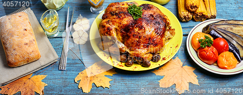 Image of Roasted chicken on wooden plate