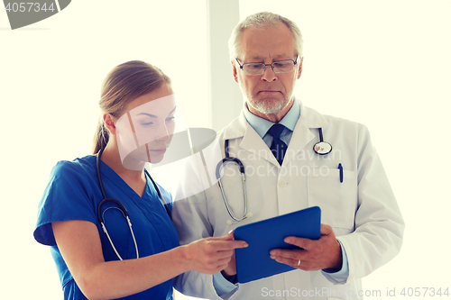 Image of senior doctor and nurse with tablet pc at hospital