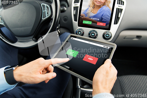 Image of close up of man with tablet pc in car