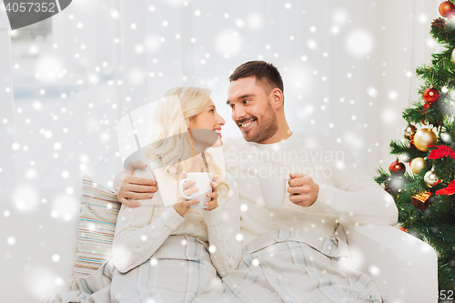 Image of happy couple at home with christmas tree