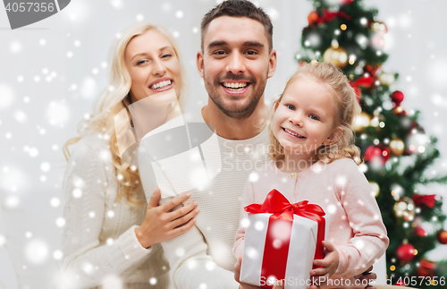 Image of happy family at home with christmas gift box