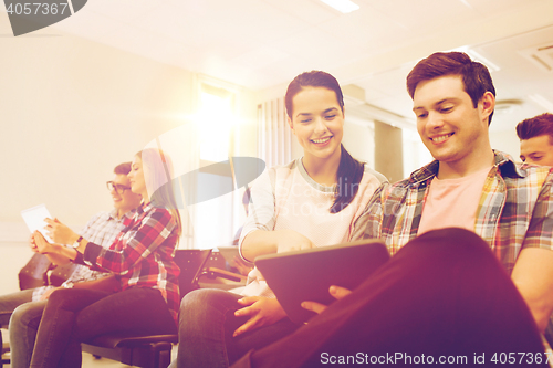 Image of group of smiling students with tablet pc