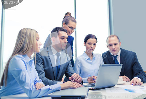 Image of business team with laptop having discussion