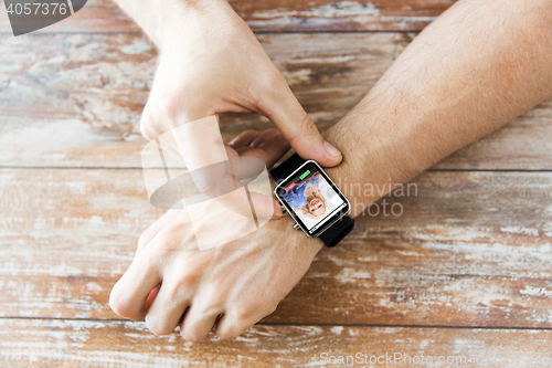 Image of close up of hands with incoming call on smartwatch