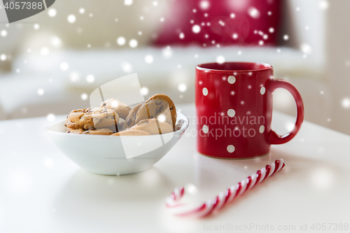 Image of close up of oat cookies, sugar cane candy and cup