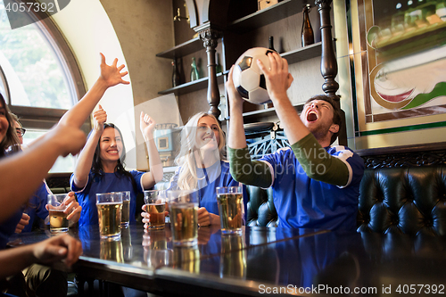 Image of football fans or friends with beer at sport bar