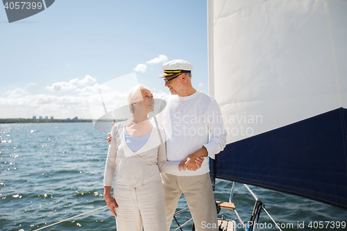 Image of senior couple hugging on sail boat or yacht in sea