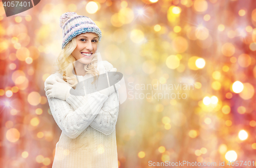 Image of smiling young woman in winter hat and sweater