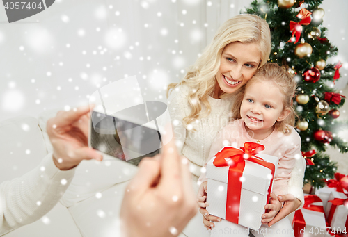Image of family taking picture with smartphone at christmas