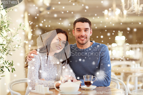 Image of happy couple drinking tea at restaurant