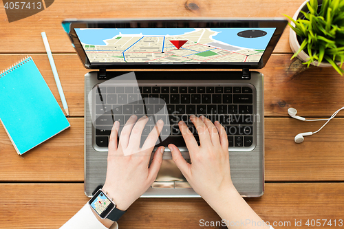 Image of close up of woman with gps navigator map on laptop