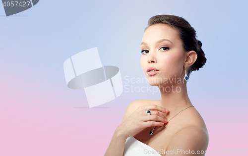 Image of beautiful woman with earring, ring and pendant