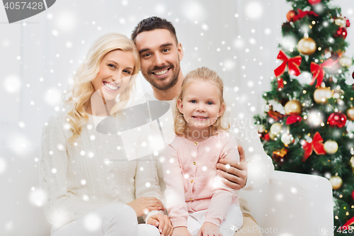 Image of happy family at home with christmas tree