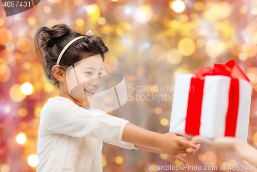 Image of smiling little girl with gift box