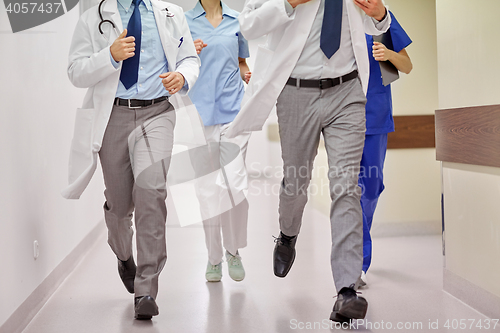 Image of close up of medics or doctors running at hospital