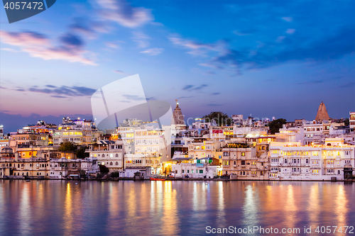 Image of Evening view of  illuminated houses on lake Pichola in Udaipur