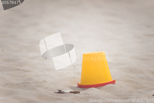 Image of Yellow bucket on a beach