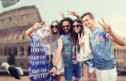 Image of hippie friends with smartphone selfie stick