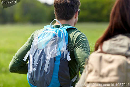 Image of close up of couple with backpacks hiking outdoors