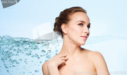 Image of beautiful young woman touching her neck