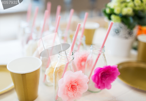 Image of close up of glass bottles for drinks with straws