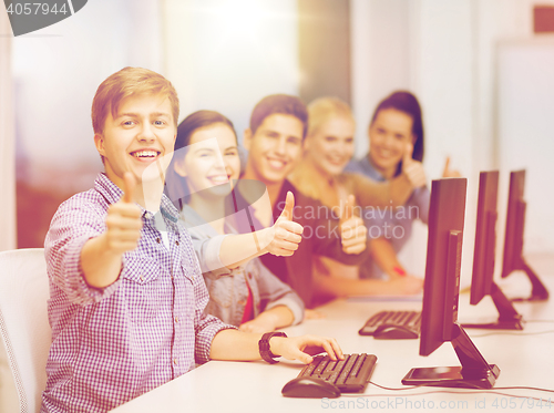 Image of students with computer monitor showing thumbs up