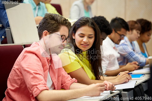 Image of group of international students writing at lecture