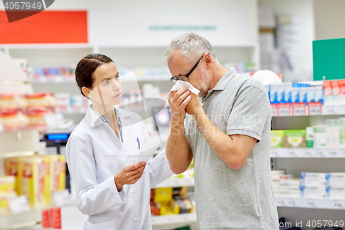 Image of pharmacist and senior man with flu at pharmacy