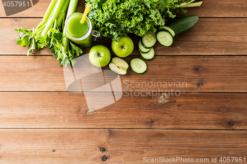 Image of close up of jug with green juice and vegetables