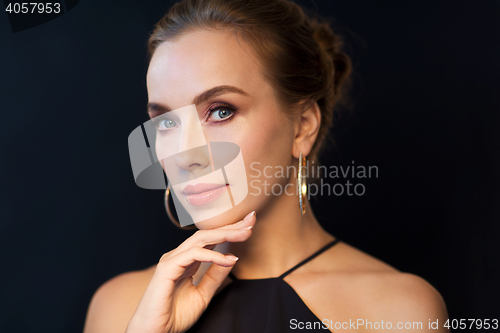 Image of beautiful woman in black wearing diamond jewelry