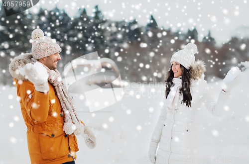 Image of happy couple playing snowballs in winter