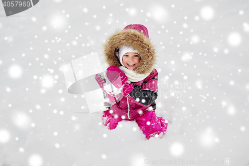 Image of f happy little child or girl with snow in winter