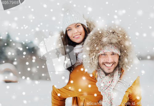 Image of happy couple having fun over winter background