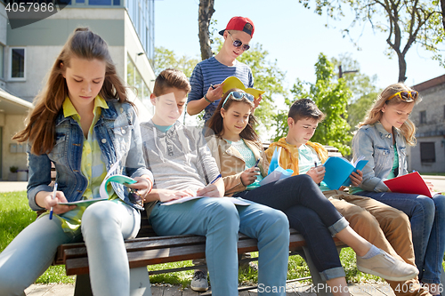 Image of group of students with notebooks at school yard