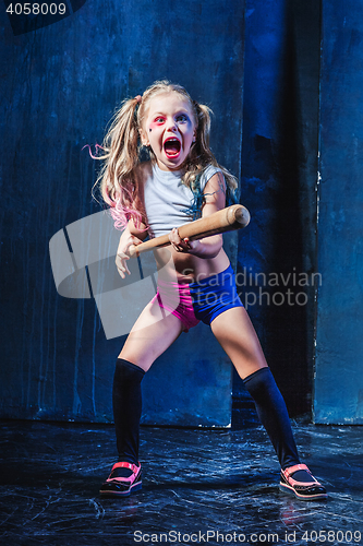 Image of Halloween theme: Girl with baseball bat ready to hit